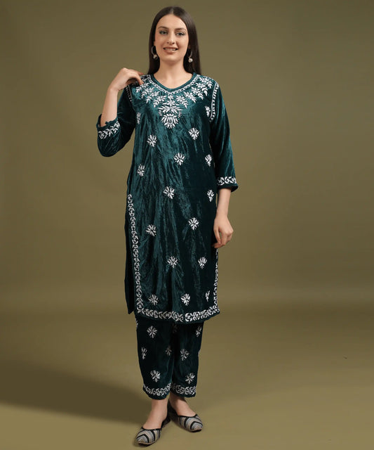 Woman wearing Ruh Lucknowi Hand Embroidered Velvet Kurta Set in Bottle Green with white floral Chikankari embroidery, front view against studio background — Noor-e-Awadh