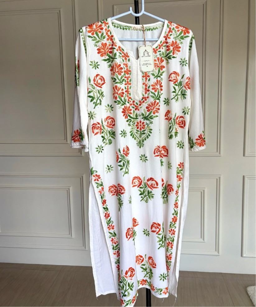 Mehram Lucknowi Chikankari white rayon kurti with shaded orange and green floral embroidery, front view full length on hanger — Noor-e-Awadh
