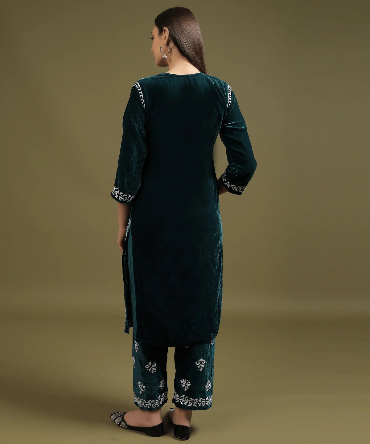 Back view of Ruh Lucknowi hand embroidered velvet kurta set in bottle green showing Chikankari embroidery on sleeves and pant hem — Noor-e-Awadh